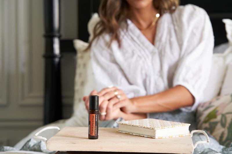 dōTERRA Ладан Touch Роллер dōTERRA Ладан Touch на деревянном подносе рядом с книгой